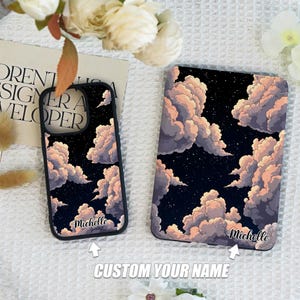 May include: Two phone cases with a night sky and clouds design. The cases are black with a white outline. The larger case has the name "Michelle" printed on the bottom. The smaller case is a phone case for a smartphone. The text "CUSTOM YOUR NAME" is printed below the cases.