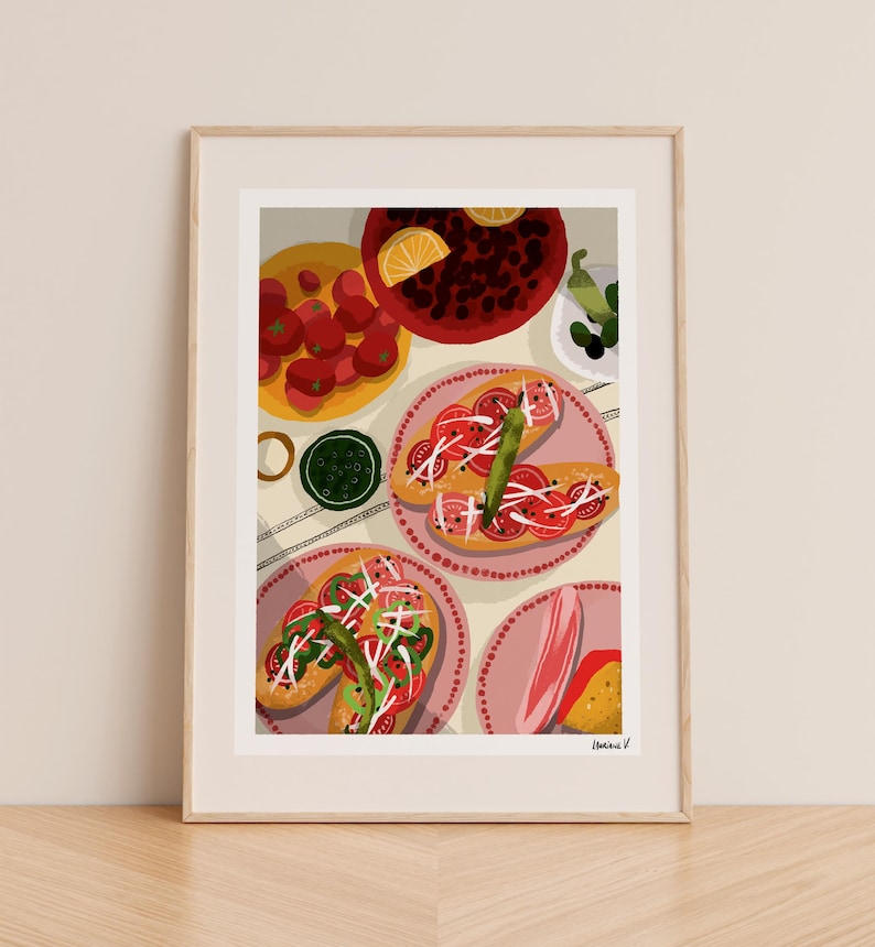 May include: A framed art print featuring a still life of food. The image showcases plates of tomatoes, bread topped with tomatoes and onions, and other dishes. The color palette includes red, green, and pink.