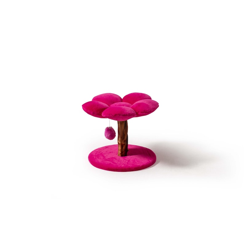 May include: Pink cat tree with a flower-shaped platform and a dangling toy. The tree has a wooden trunk and a round base.