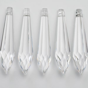 May include: Five clear crystal teardrop-shaped prisms, each with a faceted design.