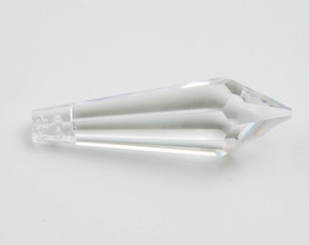 May include: A clear crystal prism with a pointed tip and a faceted design.