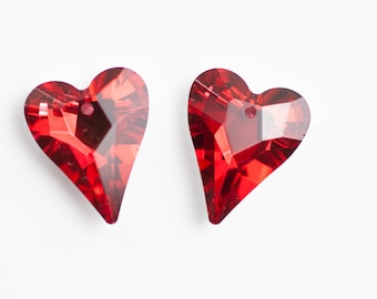 May include: Two red heart-shaped crystal embellishments with a faceted design.