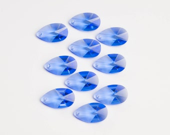 May include: Ten blue teardrop-shaped crystal beads with a faceted design.