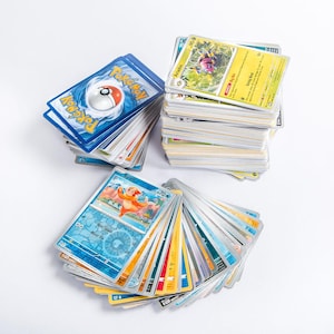 stack of pokemon cards The collection features three legendary Pokémon EX cards (Lugia ex 3,129 Pokemon Card Collection Royalty-Free
