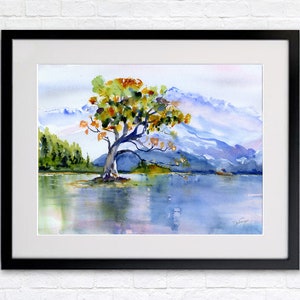 May include: Watercolour painting of a solitary tree with orange, yellow, and green leaves standing in a lake with mountains in the background.