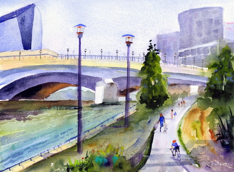May include: A watercolor painting of a bridge over a river with people walking and biking on a path along the riverbank. The bridge is made of stone and has a light yellow railing. There are two lampposts on the path, and a large building in the background.