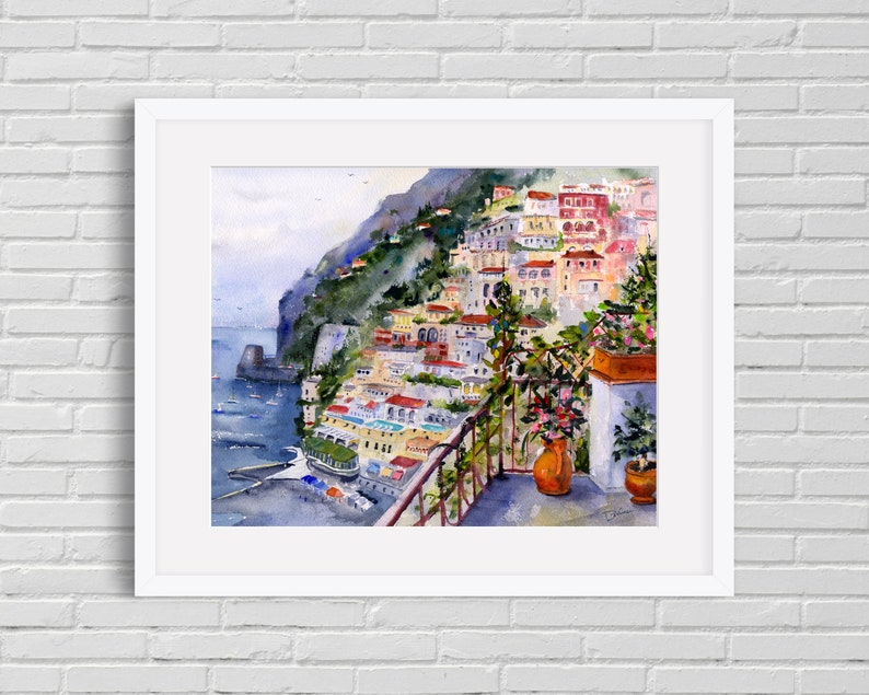 May include: Watercolor painting of a colorful Italian village on a cliffside overlooking the sea. The painting features a balcony with potted plants and a view of the ocean.