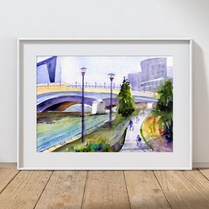 May include: Watercolor painting of a bridge over a river with people walking and biking on a path along the riverbank. The painting features a modern building in the background and streetlights along the path.