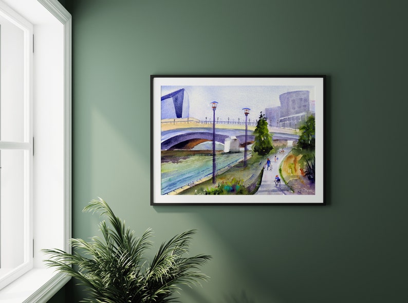 May include: Watercolor painting of a bridge over a river with a modern building in the background. People are walking and biking on the path along the river.