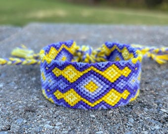 Wide friendship bracelet with diamond and flame pattern in purples and yellows