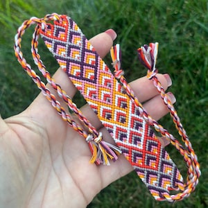 Wide dovetail friendship bracelet in bold colors of gold, pink, purple, and red