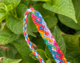 Friendship bracelet in bright colors with twisting diamond pattern