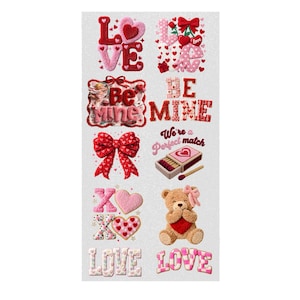 May include: Valentine's Day themed stickers with various designs. Includes the word "LOVE" in multiple styles, hearts, bows, a teddy bear, and the phrases "Be Mine" and "We're a Perfect Match". The stickers are in shades of red, pink, and white.