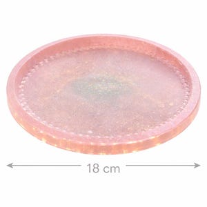 May include: A circular, pink resin tray with a beaded border. The tray measures 18 cm (7 inches) in diameter. The centre of the tray has a subtle, shimmering effect. Suitable for serving or display.
