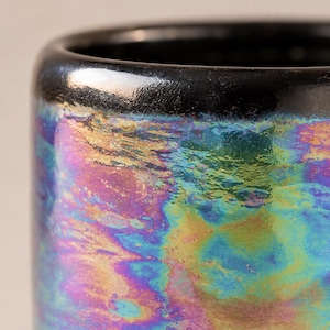 Close-up of the handmade iridescent pearl lustre showing blue, green, purple, pink and gold variations