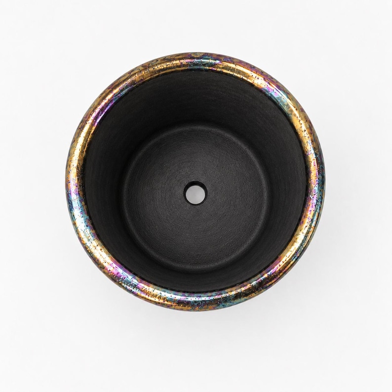 Top view of black porcelain planter showing matte unglazed interior and central drainage hole