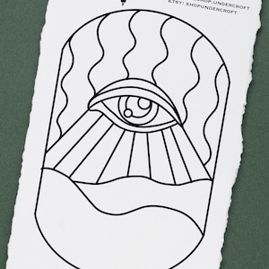 May include: Black and white line art illustration of an eye with sun rays and waves. The image includes the text "Yundercroft Art, Apparel, Oddities" and "INSTAGRAM: @SHOP.UNDERCROFT ETSY: SHOPUNDERCROFT" and "PATTERN NOT FOR RESALE OR REDISTRIBUTION".