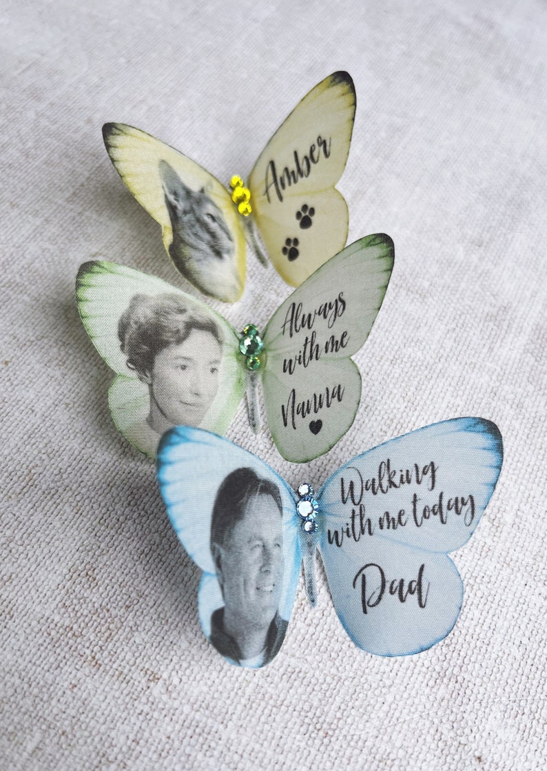 Customised little silk butterfly keepsakes, a pale yellow with an image of a cat and the name Amber. A something blue butterfly with the image of a man and the words Walking with me today Dad