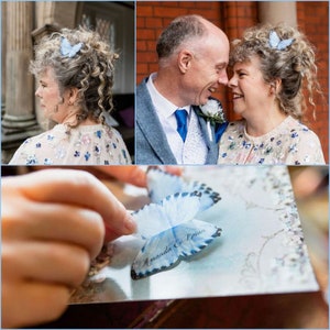 A bride with curly hair is wearing a blue silk butterfly. It has the names of the bride and groom and the wedding dates printed on the lower wings. a secret message under a top fluttery wing