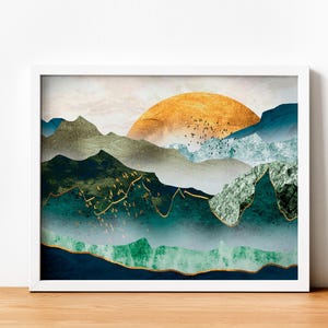 May include: Abstract art print featuring a gold sun setting behind a layered mountain range with shades of blue, green, and white.