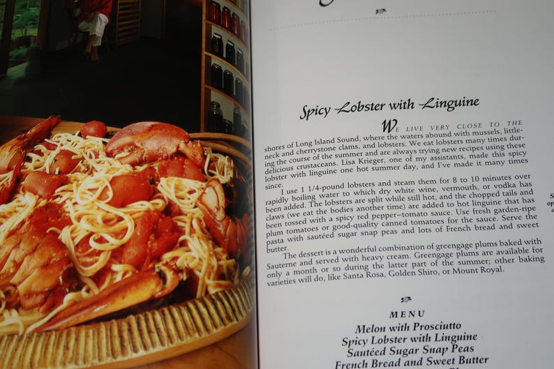 May include: A close-up of a plate of linguine pasta with lobster, tomatoes, and a red sauce. The text "Spicy Lobster with Linguine" is visible in the background.