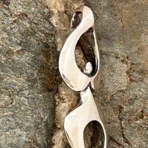 Firekeeper small, tends the sacred flame, carries the torch, keeps the hearth fires burning