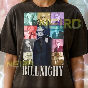 May include: Dark gray unisex t-shirt featuring a collage of images of Bill Nighy, with the name "BILL NIGHY" in white block letters. The shirt has a vintage, worn look.