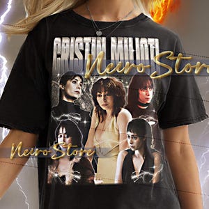 May include: Black t-shirt with a graphic featuring multiple images of a woman and the text "Cristin Milioti Neiro Store". The shirt is worn by a person with blonde hair, against a fiery background.
