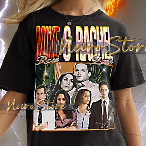 May include: Black t-shirt featuring a graphic design with the text "Mike & Rachel" and the names "Ross" and "Zane". The design includes images of people. The shirt has a distressed look.