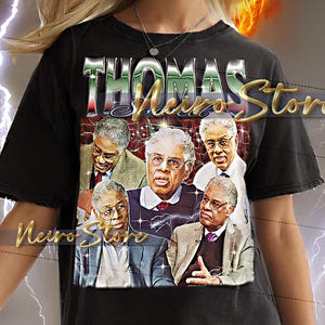 May include: Black unisex t-shirt with a graphic of several men in suits and the text "THOMAS Nero Store" in a metallic font. The background includes a lightning bolt and a fiery burst.