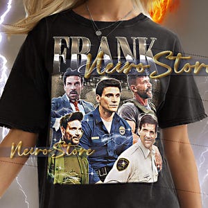 May include: Black unisex t-shirt with the text "FRANK Nero Store" in a metallic font. The shirt features a graphic of several men in various outfits. The model is wearing a 2XL shirt.