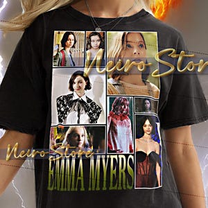May include: Black t-shirt with a collage of images and the text "EMMA MYERS" in green. The shirt has a worn appearance and is worn by a person with blonde hair. The background features a fiery design.