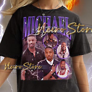 May include: Black t-shirt with a graphic of Michael B. Jordan and the text "Michael B. Jordan Store". The design incorporates several images of the actor. The shirt has a vintage, distressed appearance.