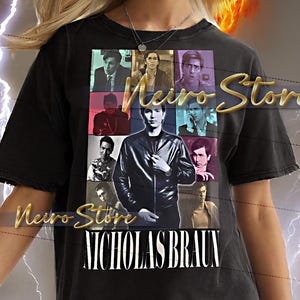 May include: Black t-shirt featuring a collage of images and the text "Weiro Store" and "NICHOLAS BRAUN." The shirt is worn by a person with blonde hair and is against a background with a yellow and orange glow and lightning.