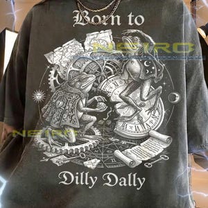 May include: A white ceramic mug with a black handle and the text "But First, Coffee" in a bold, black font. The mug is set against a blurred background, suggesting a cozy setting.