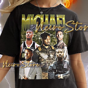 May include: Black t-shirt featuring a graphic of Michael B. Jordan and the text "Michael B. Jordan". The shirt has a vintage style design with a distressed look. The model is wearing a 2XL shirt.