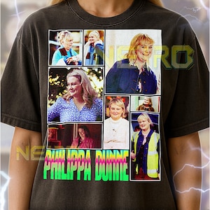May include: Dark gray unisex t-shirt featuring a collage of images of Philippa Dunne. The shirt has the name "PHILIPPA DUNNE" in a neon green and pink font. The shirt also has text at the bottom.