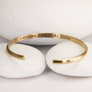 Personalized Custom Stamped Wide Gold Cuff with Brushed/Matte Finish by Lotus Stone Jewelry on white stones