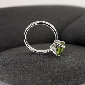 Solid sterling silver peridot gemstone ring by Lotus Stone Jewelry on black stones