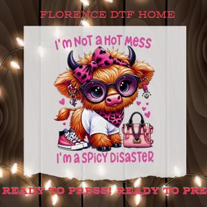 May include: A digital graphic featuring a cartoon cow with orange fur, wearing glasses, a bow, and a scarf with a pink and black polka dot pattern. The cow is wearing a white shirt and pink sneakers. Text reads "I'm Not a Hot Mess" and "I'm a Spicy Disaster."