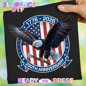 May include: Black graphic featuring a bald eagle with outstretched wings, holding arrows, set against a US flag design. The design includes the text "1776-2026" and "250th Anniversary" in a circular banner.