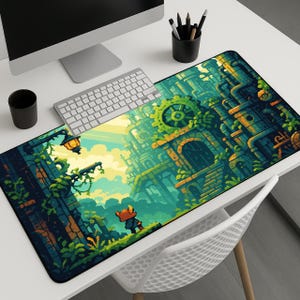 May include: A large rectangular desk mat featuring a pixelated fantasy landscape with a character in the foreground. The design incorporates green, blue, and yellow hues, with gears and architectural elements. A keyboard, monitor, and accessories are visible.