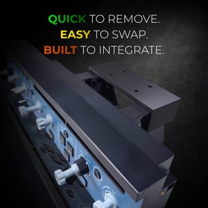 May include: A black and blue control panel with white knobs and buttons. The text "QUICK TO REMOVE. EASY TO SWAP. BUILT TO INTEGRATE." is displayed in green, yellow, and orange. The panel has a metallic finish and is designed for integration.
