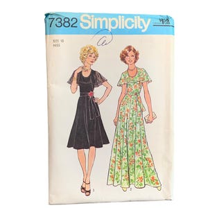 May include: Vintage Simplicity sewing pattern 7382. The pattern features illustrations of two dresses: a black knee-length dress with a floral belt and a green floral maxi dress. The pattern is size 10, Miss.