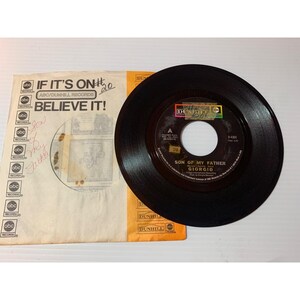 May include: A vintage black vinyl record with the song title "Son of My Father" by Giorgio. The record is in its original ABC/Dunhill Records sleeve, which has the text "If It's On Believe It!" and handwritten notes.