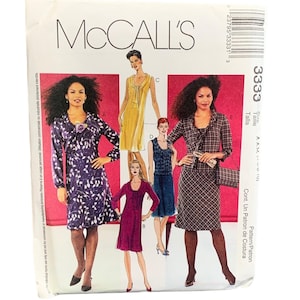 May include: A McCall's 3333 sewing pattern envelope featuring illustrations of five different dress styles. The designs include a long-sleeved purple leaf-print dress, a sleeveless yellow dress, a magenta dress, a blue textured dress, and a plaid dress.