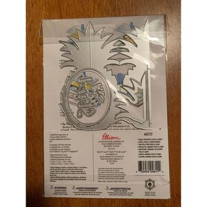 May include: A die-cut set for crafting, featuring a pineapple design with the word "Just" in a circular frame. The set includes various shapes and sizes, suitable for paper crafting projects. The packaging is clear plastic.