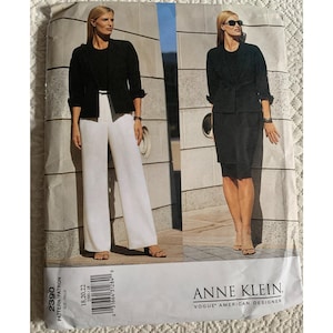 May include: A sewing pattern for Anne Klein designs, featuring a black blazer and white pants ensemble, and a black skirt suit. The pattern number is 2390, with sizes 18, 20, and 22. The Vogue American Designer logo is visible.