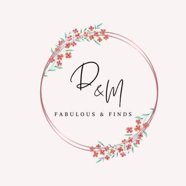 May include: A logo featuring a double pink ring with floral accents and the text "D&M FABULOUS & FINDS" in a delicate script font. The flowers are orange and pink.