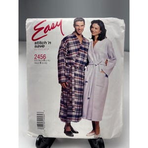 May include: A sewing pattern package featuring a man and woman in robes. The package has the word "Easy" in red script. The pattern number is 2456, with size B (L-XL) and a McCall's label.
